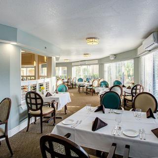 An elegant restaurant interior with neatly arranged tables and chairs.