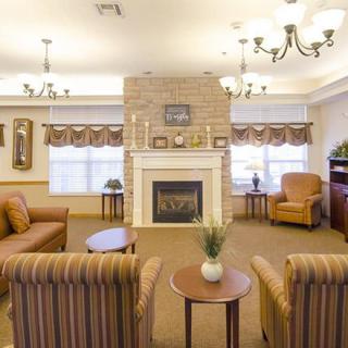 A cozy living room with a fireplace, comfortable seating, and elegant lighting.