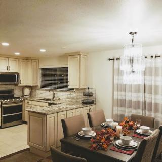 A beautifully designed kitchen and dining area, showcasing a modern aesthetic with elegant table settings.