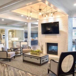 A modern living room with elegant furniture, a fireplace, and contemporary lighting.