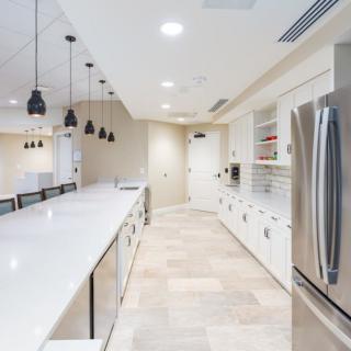 A sleek, modern kitchen with stainless steel appliances and ample lighting.