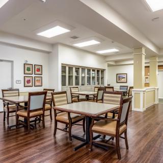 Modern dining area with wood flooring and simple decor.