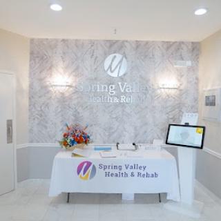 A modern and welcoming reception area of a wellness spa, featuring floral arrangements and informative displays.