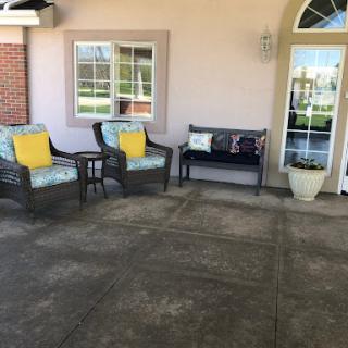 A cozy outdoor seating area featuring stylish chairs and a bench, perfect for relaxation.