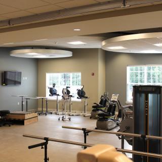 A modern fitness center with various exercise equipment, including treadmills and exercise bikes.