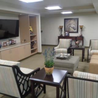 A modern living room with comfortable seating, a large television, and tasteful decor.