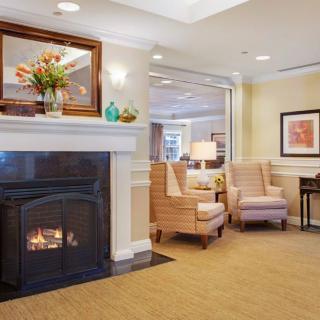 A cozy living room with a warm fireplace, comfortable seating, and tasteful decor.