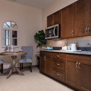 A cozy kitchen with wooden cabinets, a small dining area, and modern appliances.