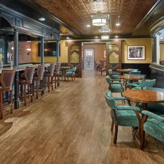 Cozy bar and restaurant interior with wooden flooring and comfortable seating.