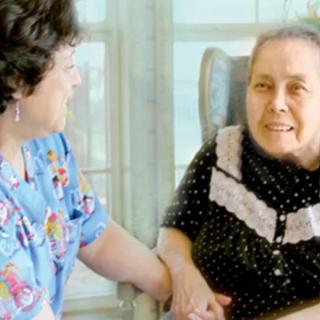Two women sharing a moment of conversation indoors.
