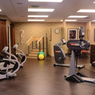 A well-equipped gym featuring exercise bikes and a treadmill in a spacious indoor setting.