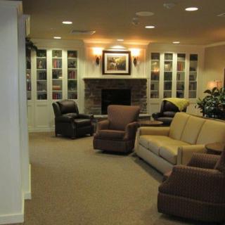 A cozy living room with comfortable seating and a warm fireplace.