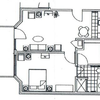 A floor plan illustrating the layout of an apartment with designated living areas and furniture arrangement.
