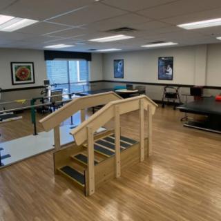 A well-equipped physical therapy room with exercise equipment and facilities.