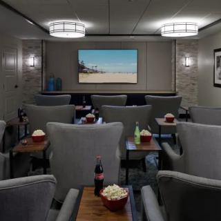 A cozy, small theater with comfortable seating and snacks ready for a movie screening.