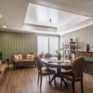 A cozy living and dining area with elegant furniture and warm lighting.
