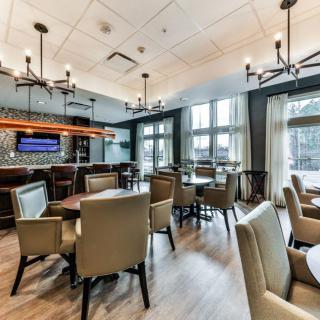 A modern restaurant interior featuring comfortable seating and elegant lighting.