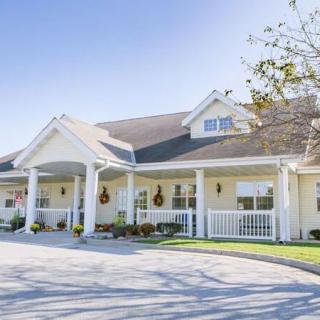 A suburban residential house with a front porch and well-maintained exterior.