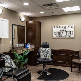 A cozy and inviting hair salon setup with comfortable seating and a stylish barber chair.
