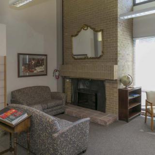 A cozy living room with a fireplace and comfortable seating.