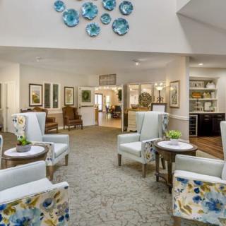 A beautifully designed lobby area with stylish chairs and tables, accented by artistic wall decor.