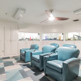 A cozy home theater setup featuring blue recliner chairs and modern interior design.