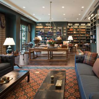 A cozy library with bookshelves, comfortable seating, and warm lighting.