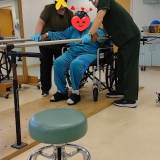 Patients receiving assistance during physical therapy sessions.