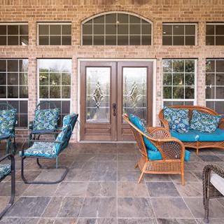 A cozy outdoor patio featuring comfortable seating and decorative cushions.