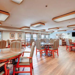 A bright dining area with neatly arranged tables and chairs.
