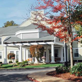 A charming building surrounded by colorful autumn foliage.