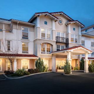 A residential building with a welcoming entrance lit up in the evening.