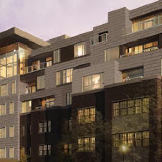A contemporary multi-story residential building showcasing a mix of materials and urban design.