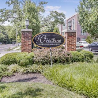 Entrance sign of a residential apartment complex surrounded by well-maintained landscaping.