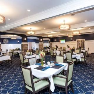 Elegant dining room with neatly arranged tables and ambient lighting.