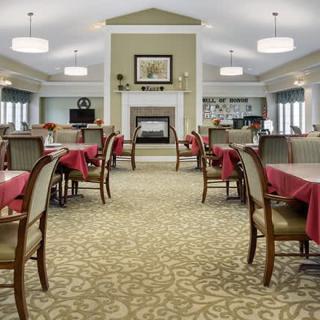An elegant dining room interior with neatly arranged tables and chairs.