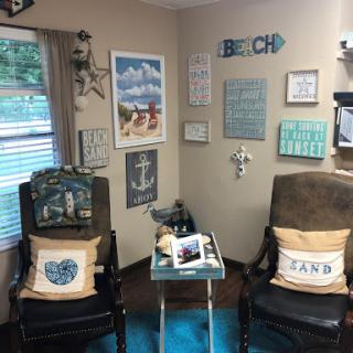 A cozy beach-themed corner in a living room, featuring comfortable seating and decorative elements that evoke a seaside atmosphere.