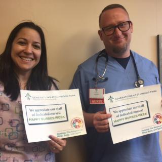 Two healthcare professionals holding signs in appreciation of their work.