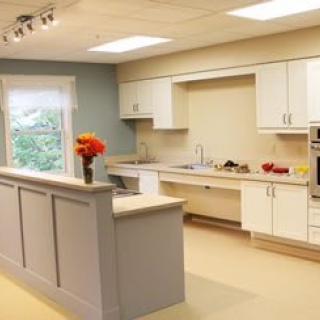 A modern kitchen with white cabinetry and sleek appliances.