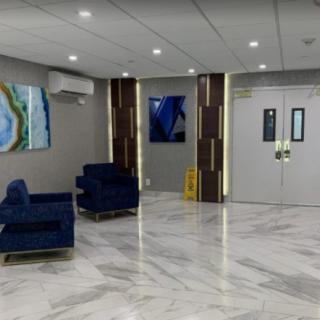 A modern waiting area with comfortable seating and art pieces on the walls.