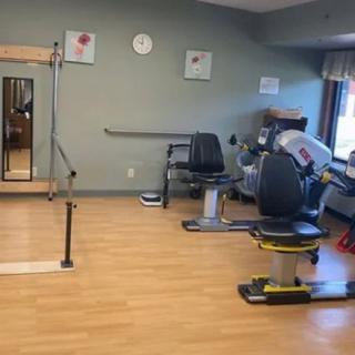 A therapy room with exercise equipment for rehabilitation and fitness activities.