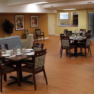 A cozy dining area with neatly set tables and comfortable seating.