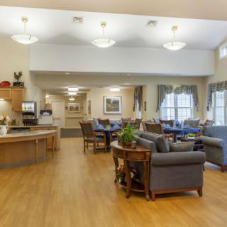 A cozy community living room with comfortable seating and warm lighting.