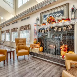 A cozy living room with a decorated fireplace and comfortable seating.