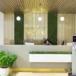 A modern reception area with green accents and stylish lighting.