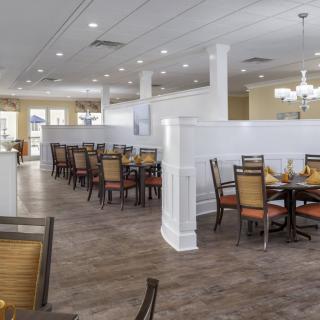 A modern restaurant dining area with neatly arranged tables and chairs.