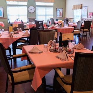 An elegantly set dining area with neatly arranged tables and chairs.