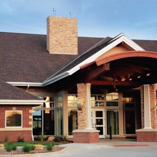 A modern building with a prominent entrance and brick exterior.