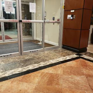 A well-designed lobby entrance featuring glass sliding doors and elegant flooring.