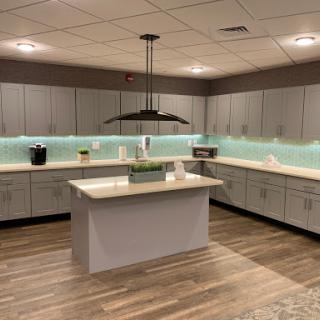 A modern and minimalist kitchen featuring sleek cabinets, a spacious countertop, and stylish lighting.